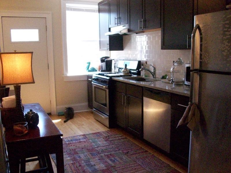 a kitchen with stainless steel appliances and black cabinets