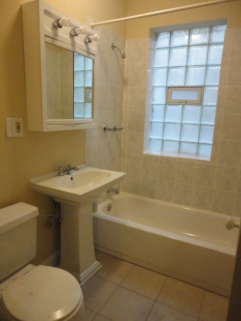 a bathroom with a sink toilet and a bath tub