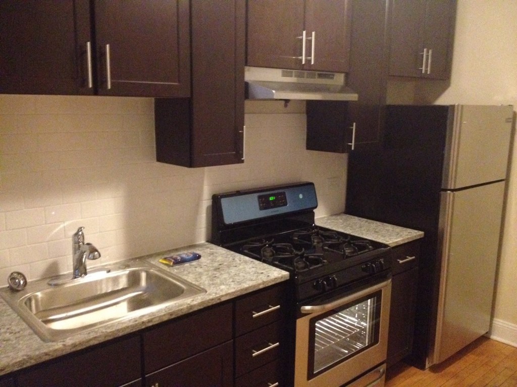 a small kitchen with a stove and a sink