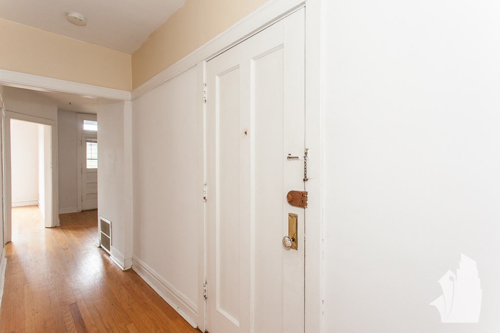 an empty room with white walls and a door with a handle