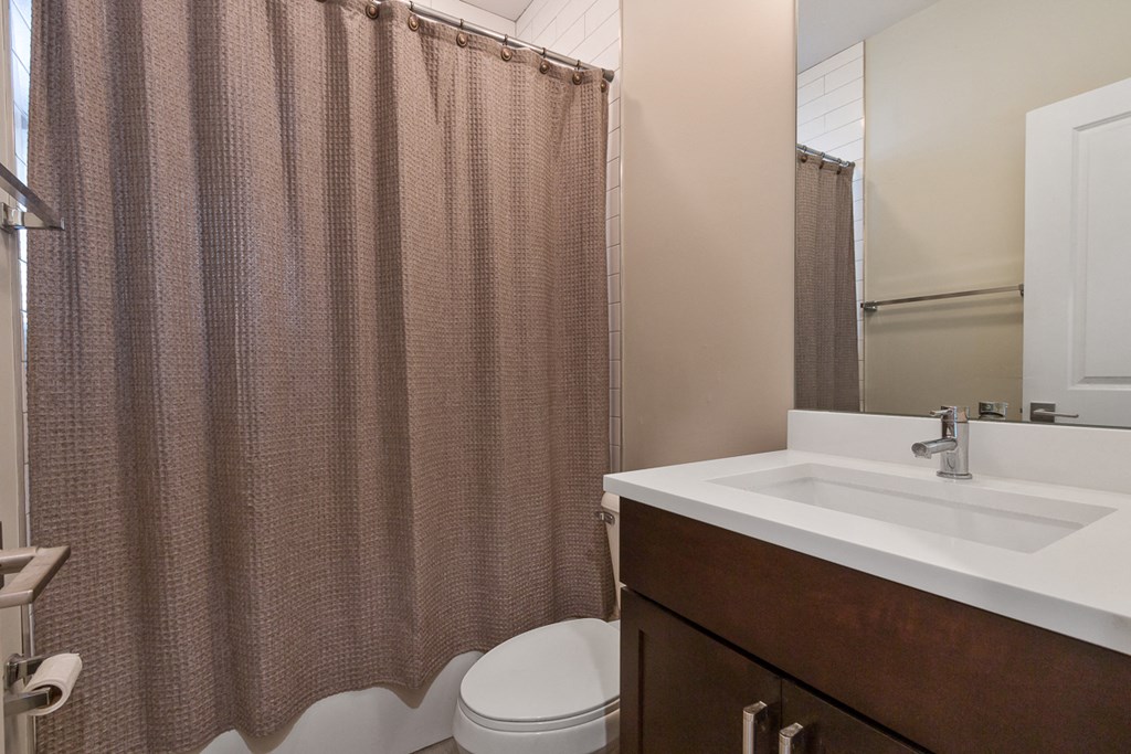 the preserve at ballantyne commons apartment bathroom with sink toilet and shower