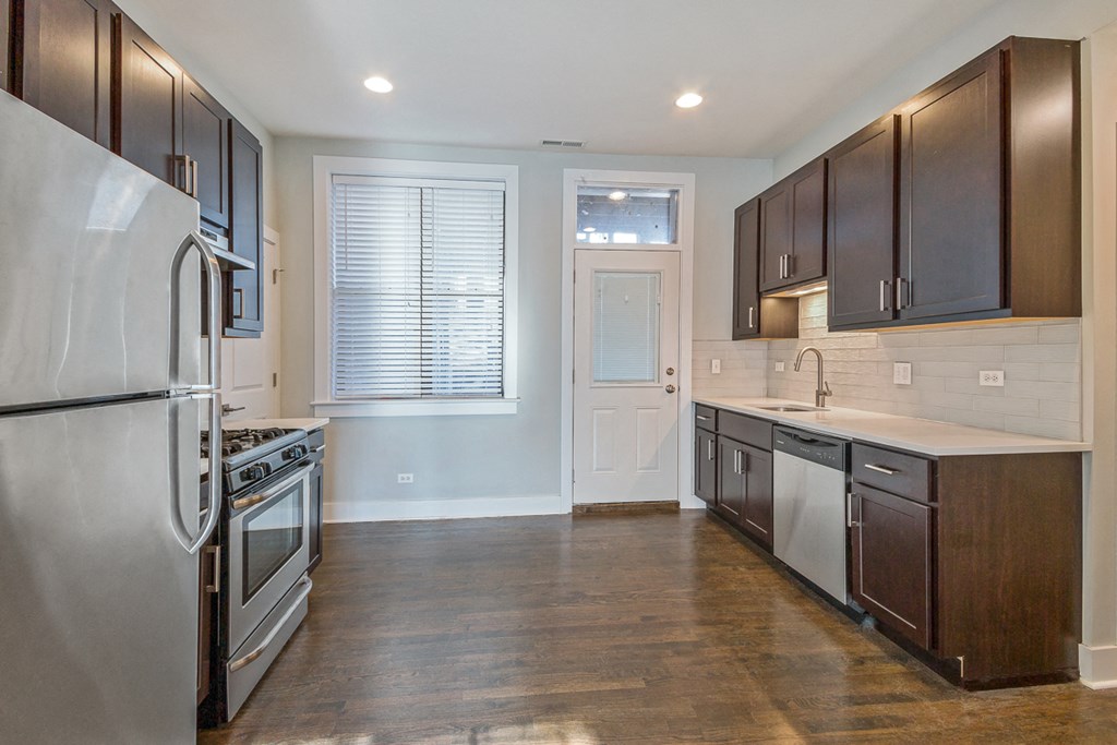 a kitchen with stainless steel appliances and wooden cabinets