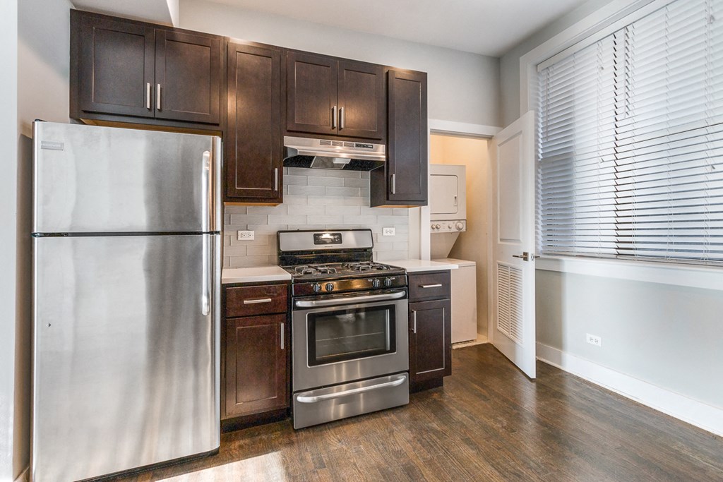 a kitchen with stainless steel appliances and wooden cabinets