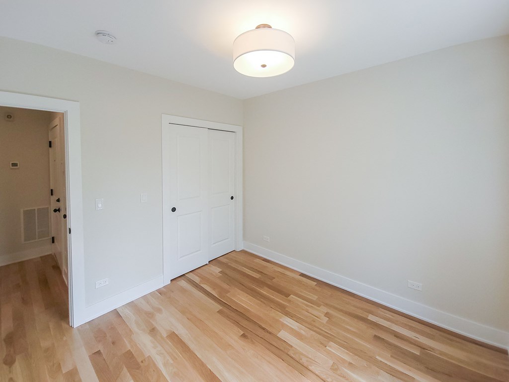 a living room with wood flooring and a white door