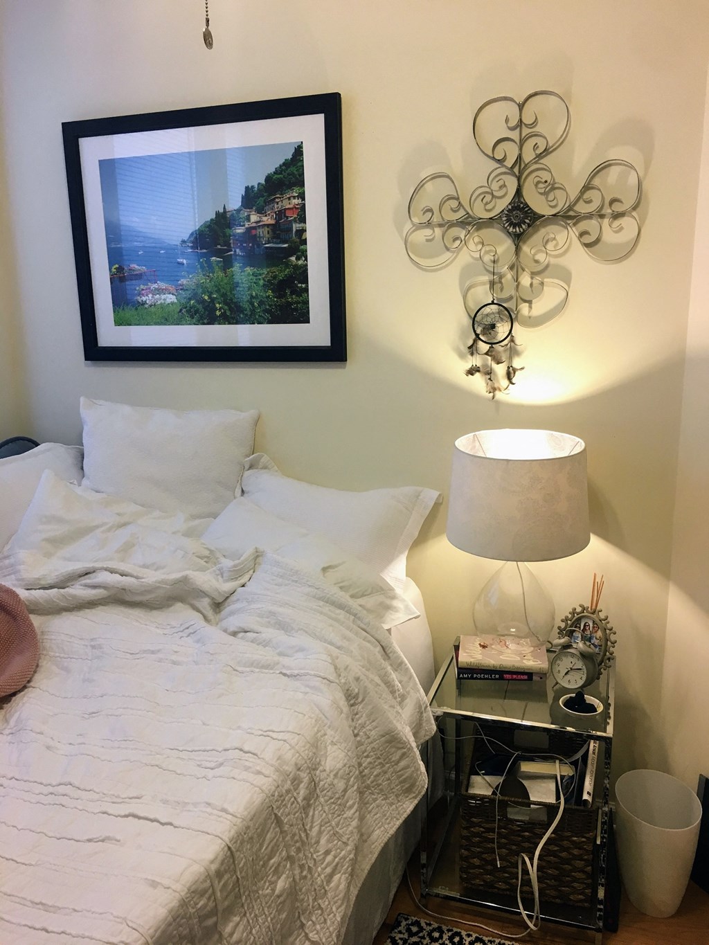 a bedroom with a picture on the wall above a bed