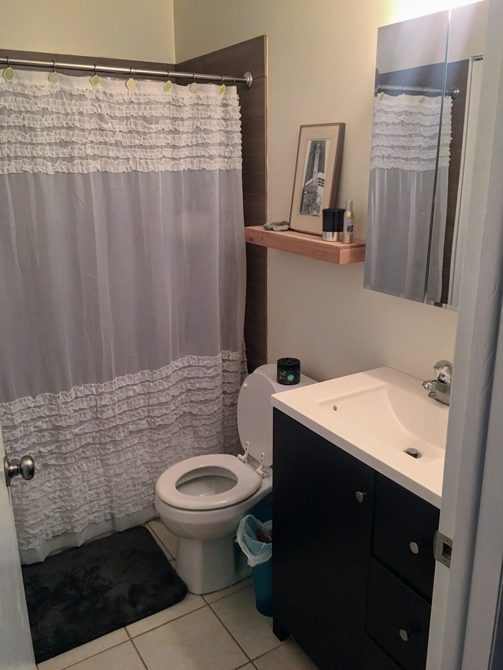 a bathroom with a shower and a toilet and a sink