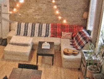 a living room with a couch and tables and lights