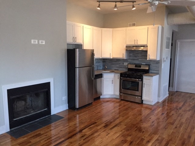 a kitchen with stainless steel appliances and a fireplace