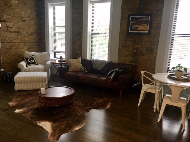 a living room with a couch and a table and chairs