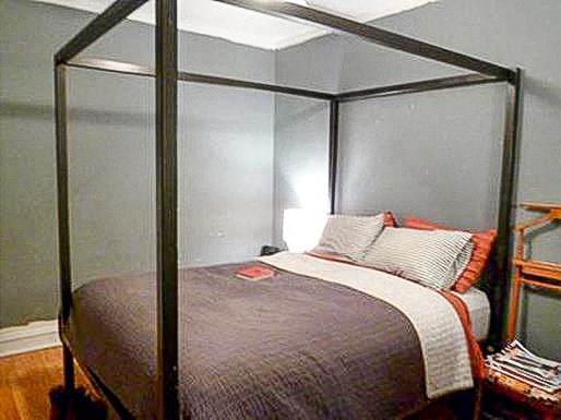 a bedroom with a bed with a canopy