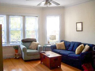 a living room with a blue couch and a chair