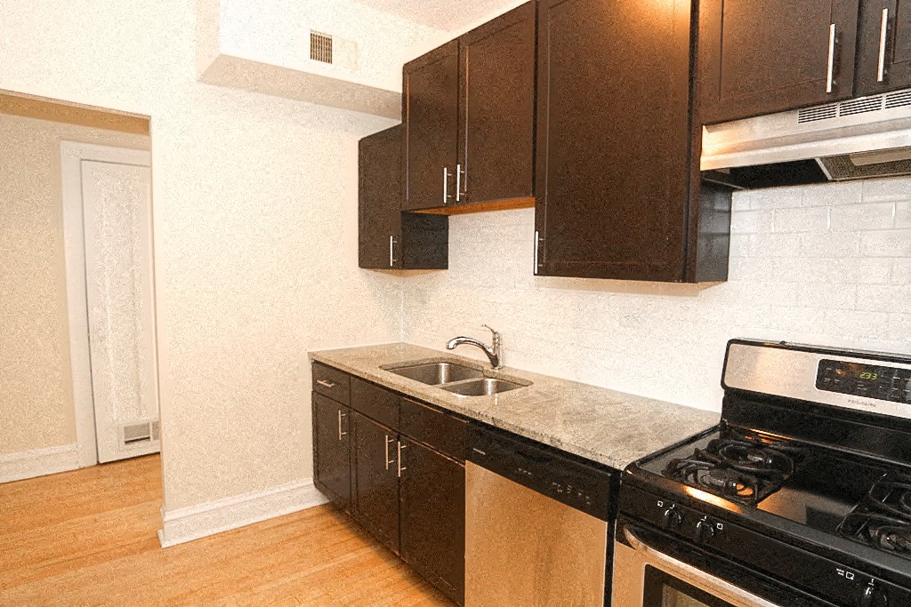 a kitchen with a sink and a stove