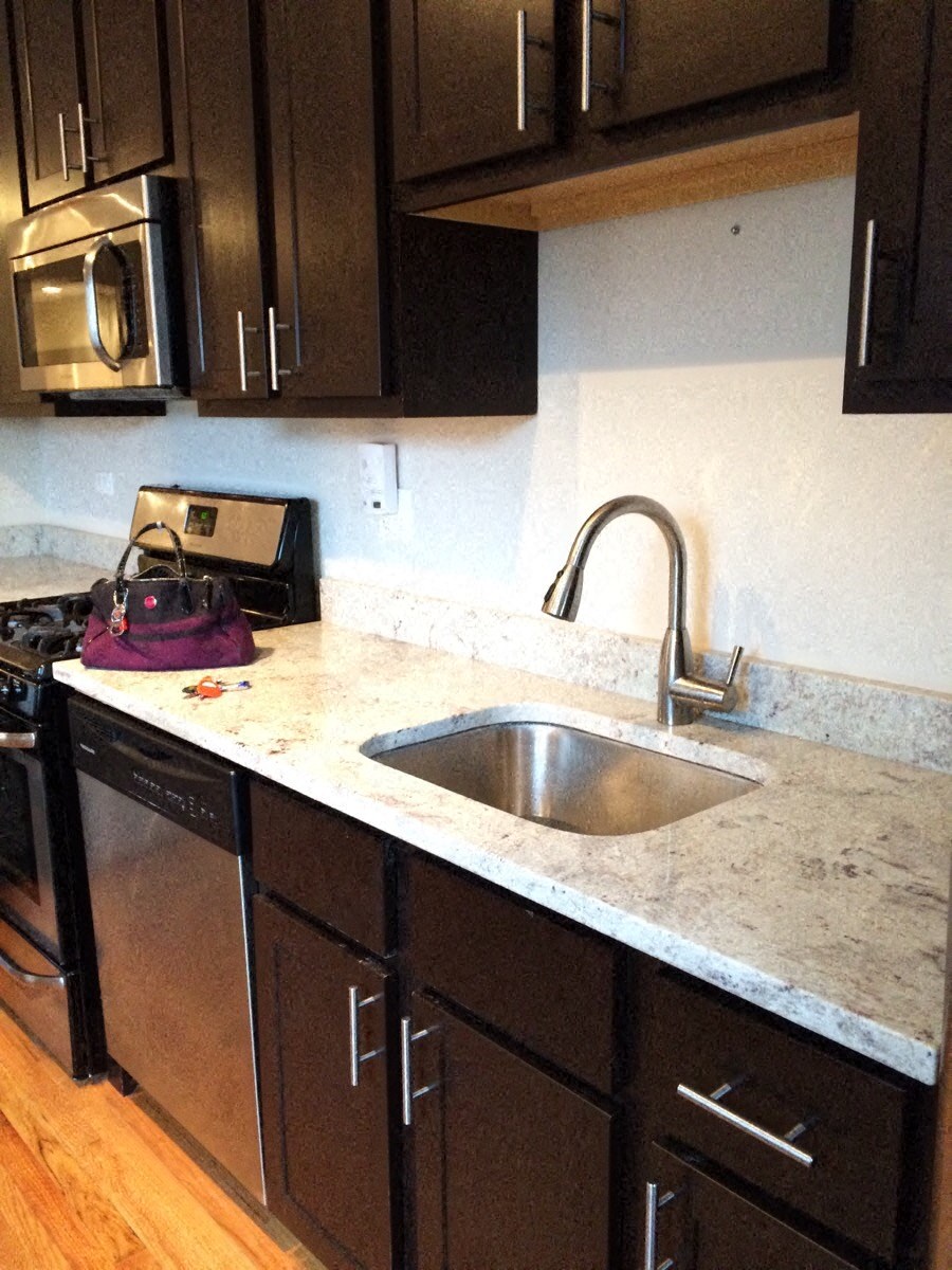 a kitchen with a sink and a counter top