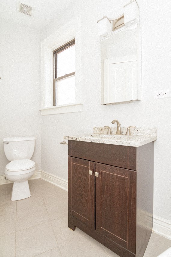a bathroom with a toilet and a sink and a mirror