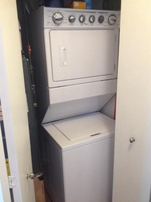 a white washer and dryer in a small closet