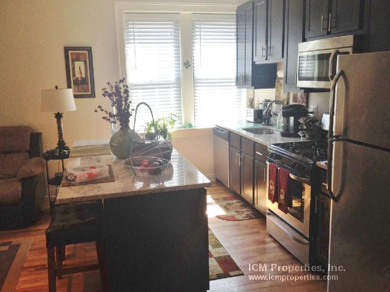 a kitchen with stainless steel appliances and a granite counter top