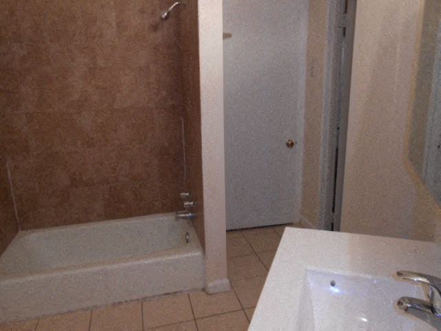 a bathroom with a bath tub and a sink