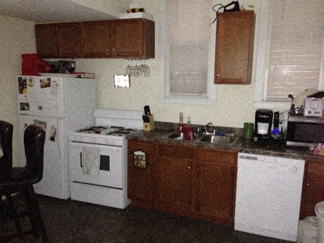 a kitchen with a stove refrigerator and sink