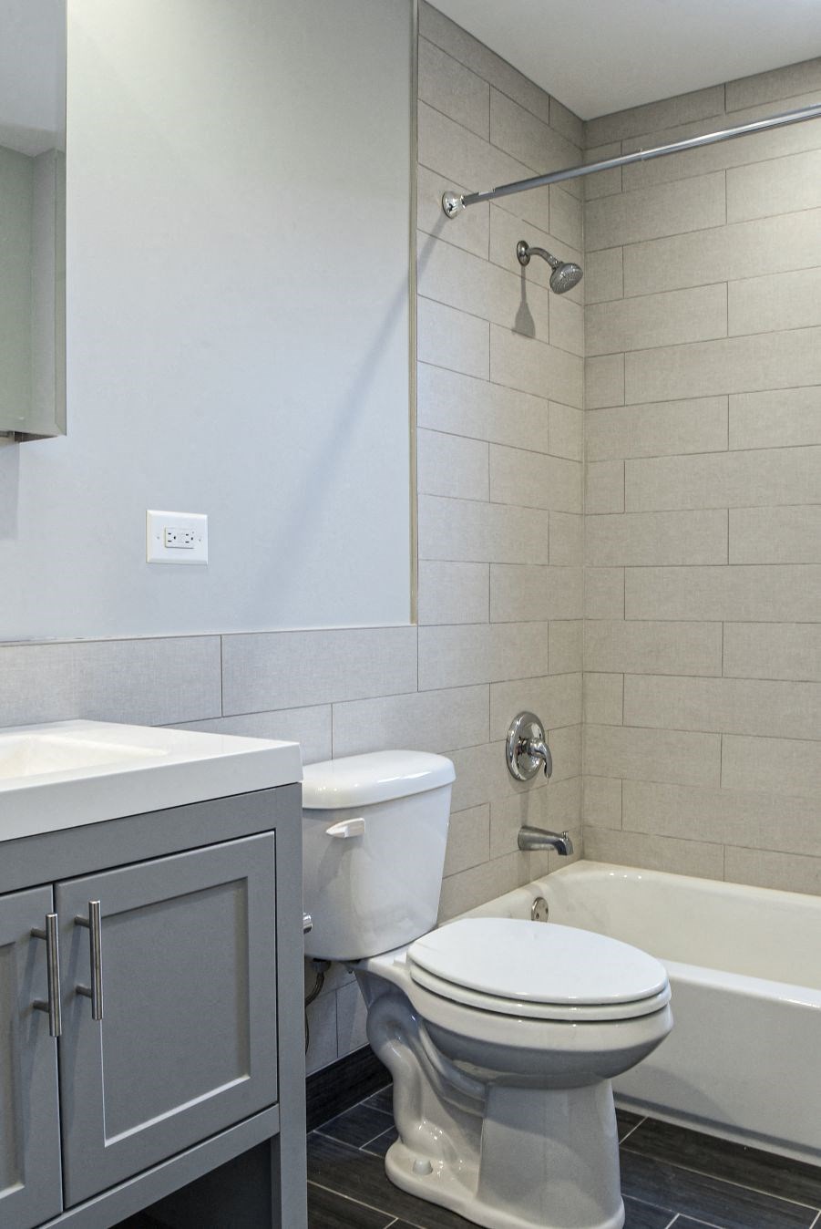 a bathroom with a toilet and a tub and a sink