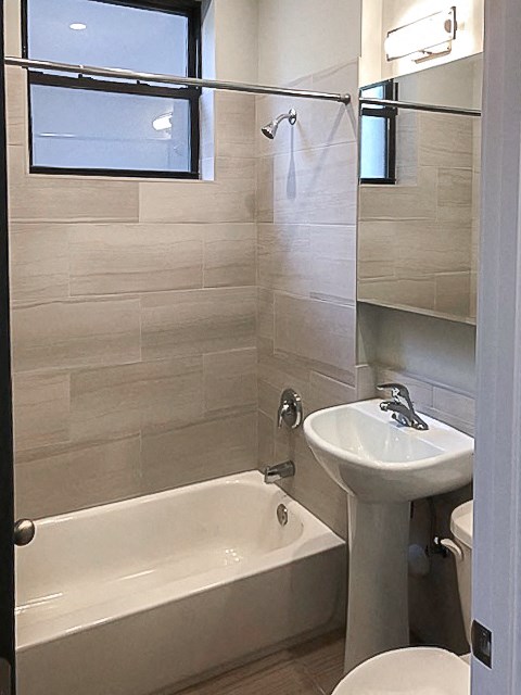 a bathroom with a sink toilet and a bath tub