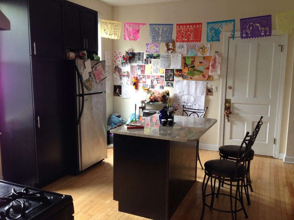 a kitchen with a counter and a refrigerator