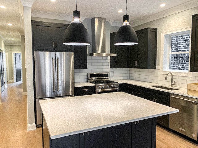 a kitchen with a counter top and a refrigerator