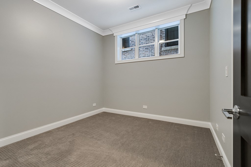 an empty room with carpet and a window