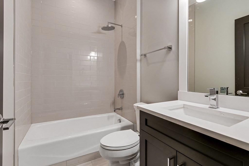 a bathroom with a sink and a toilet and a shower