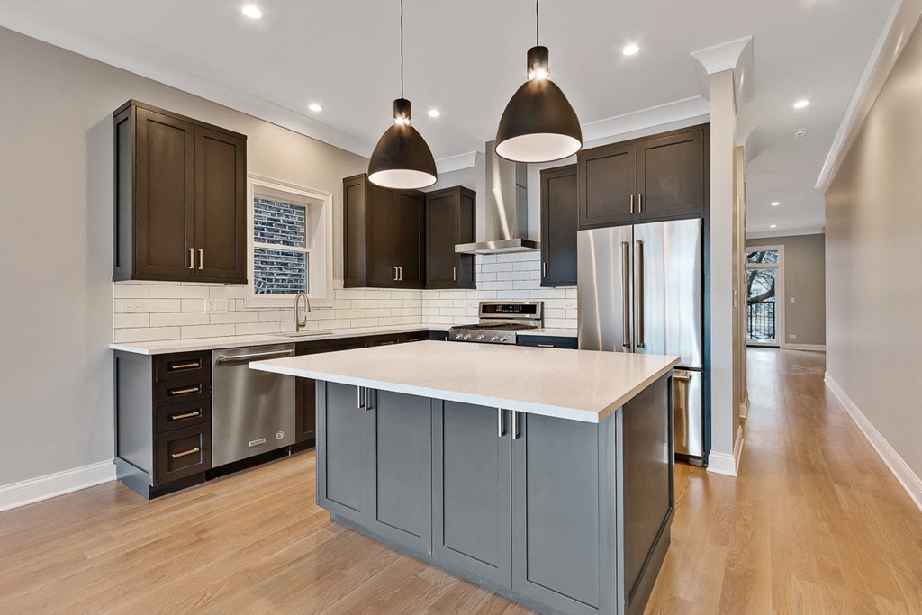 a kitchen with a large island in the middle of it
