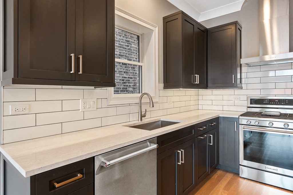 a kitchen with black cabinets and a sink