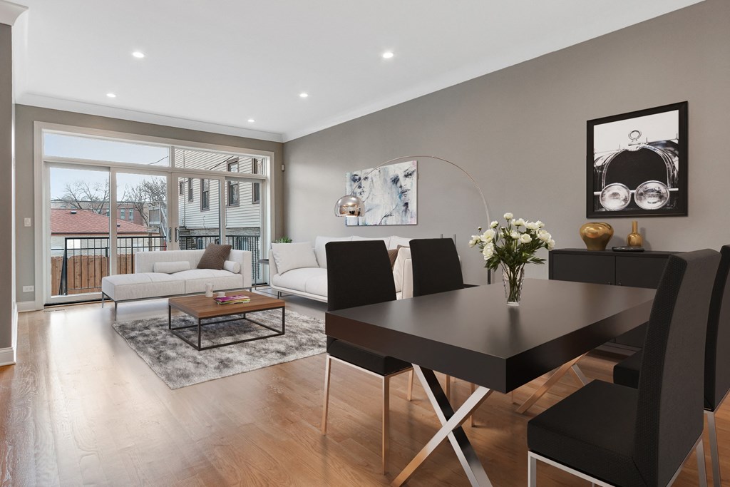 a living room and dining room with a table and chairs
