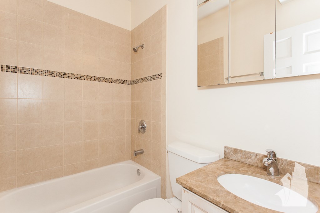 a bathroom with a sink toilet and a bath tub