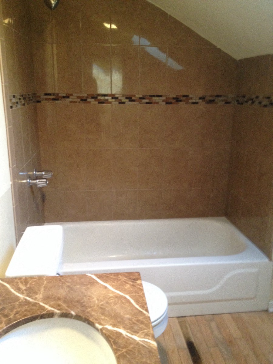 a bathroom with a tub and a sink and a toilet