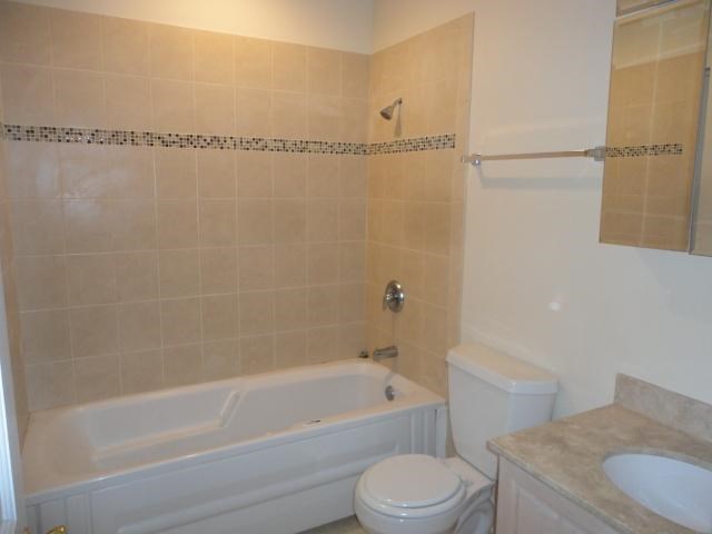 a bathroom with a toilet and a tub and a sink