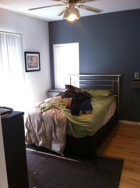 a bedroom with a bed and a ceiling fan