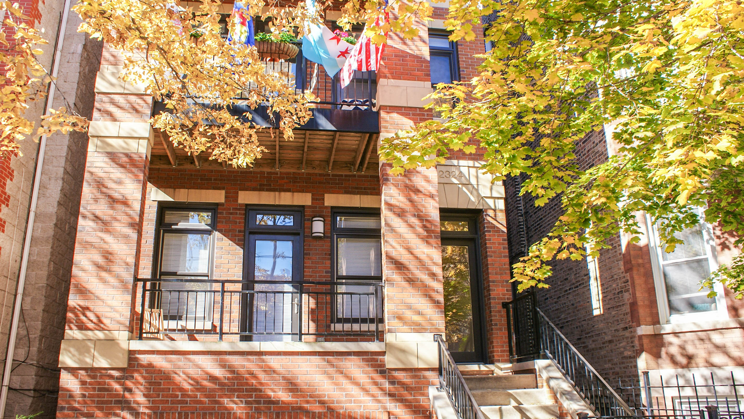 a view of a brick apartment building with stairs and a balcony