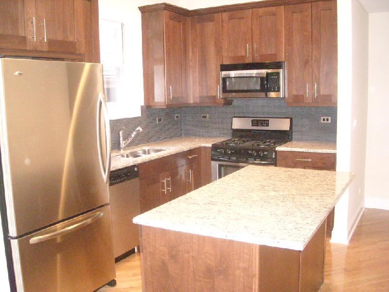 a kitchen with stainless steel appliances and wooden cabinets
