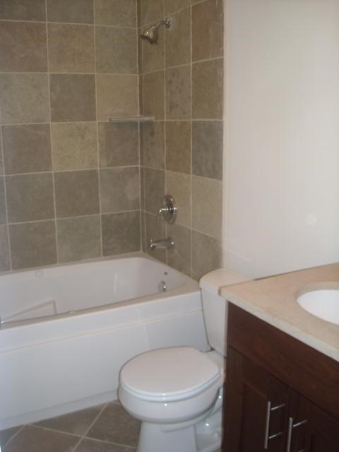 a bathroom with a toilet and a tub and a sink