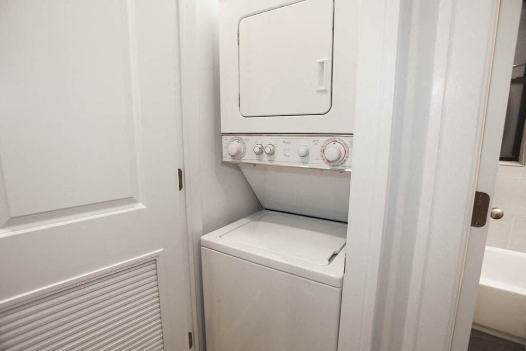 a small white washer and dryer in a white room