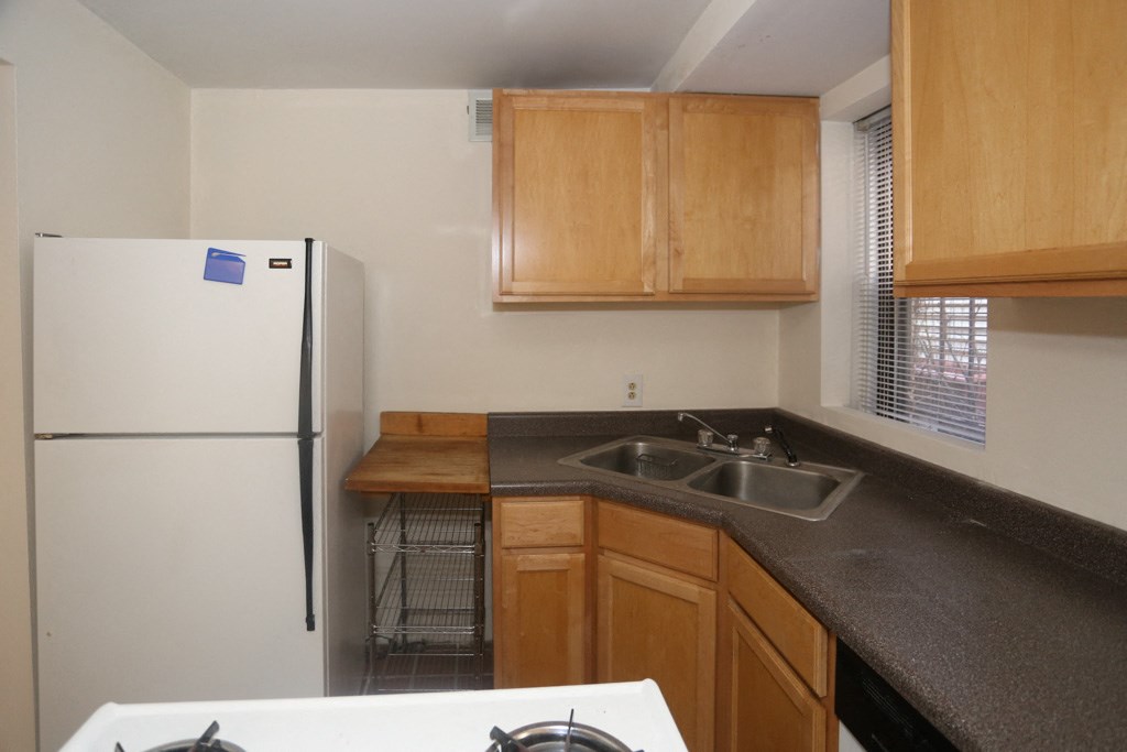 a kitchen with a sink and a refrigerator