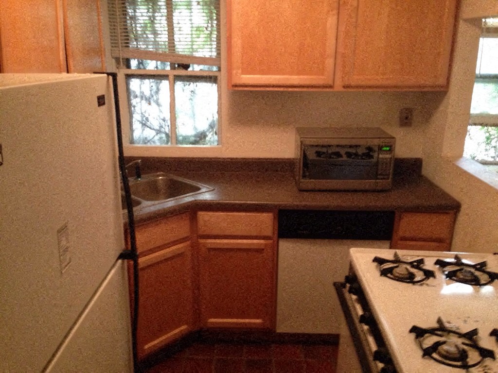 a small kitchen with a stove and a refrigerator