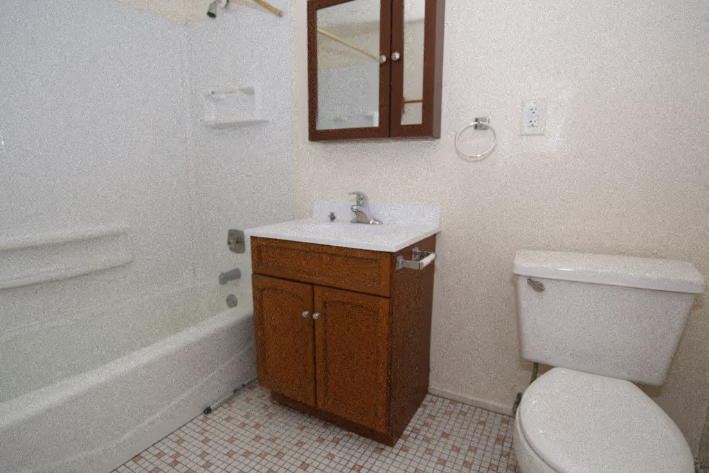 a bathroom with a toilet and a sink and a bath tub