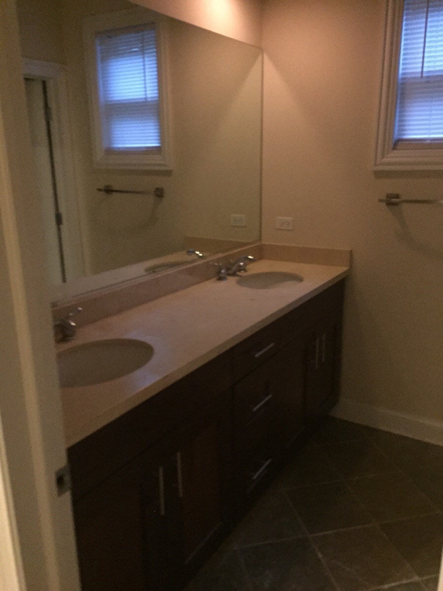 a bathroom with two sinks and a large mirror