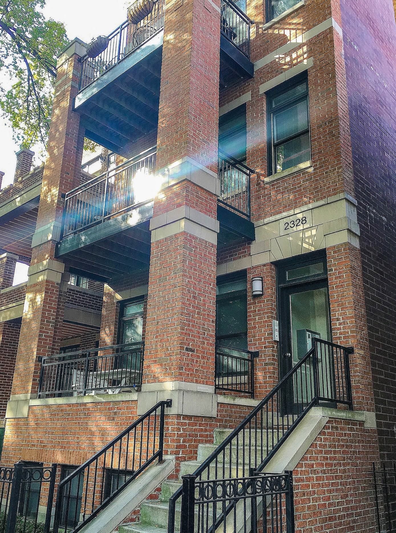 a brick apartment building with stairs and balconies