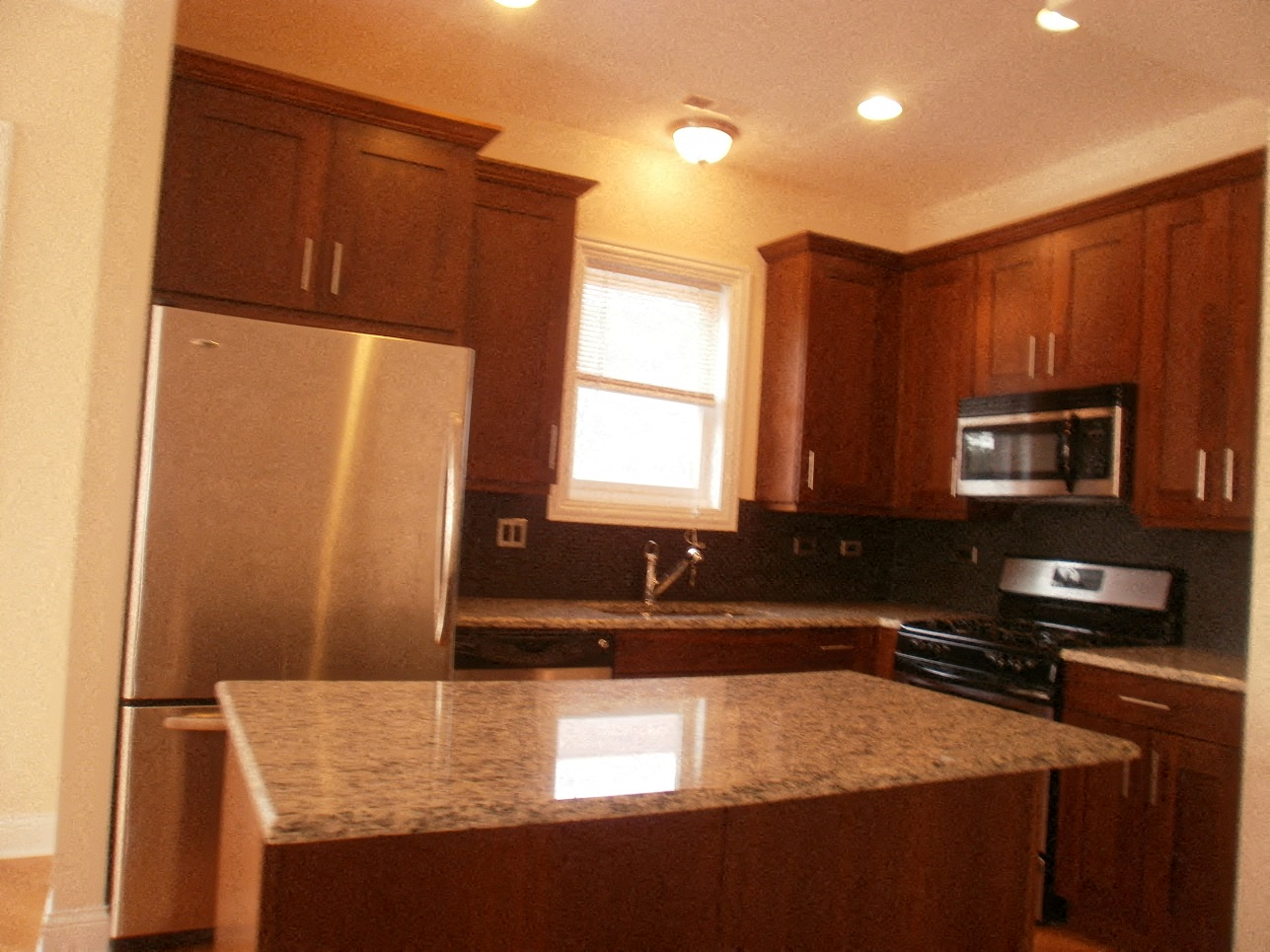 a kitchen with stainless steel appliances and a granite counter top
