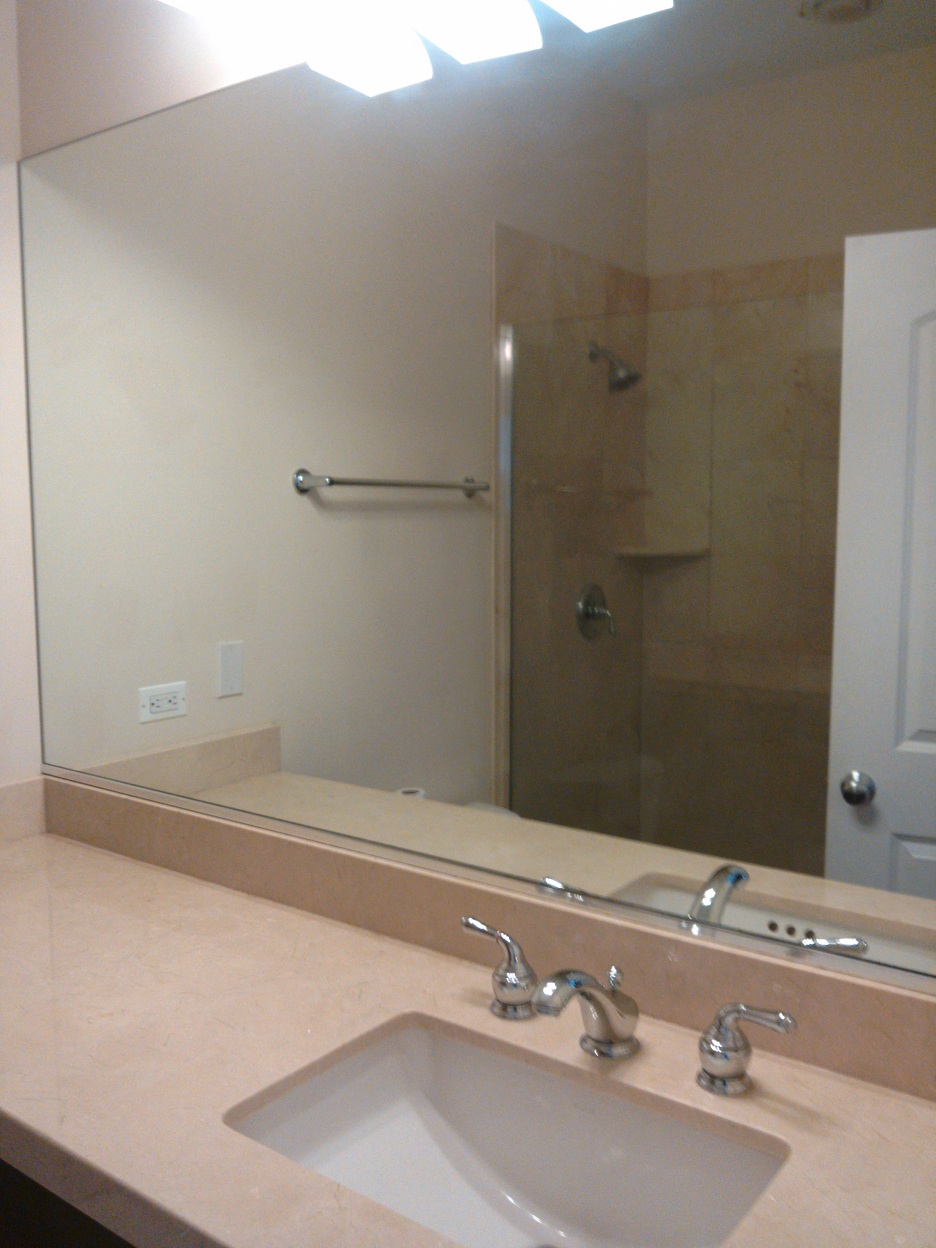 a bathroom with a sink and a large mirror