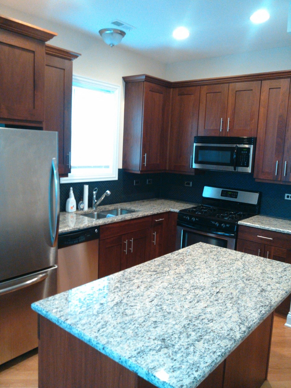 a kitchen with a granite counter top and stainless steel appliances