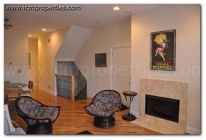 a living room with two chairs and a fireplace