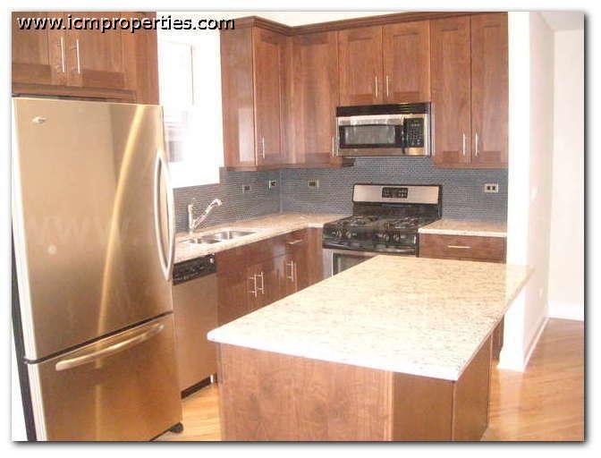 a kitchen with wooden cabinets and stainless steel appliances
