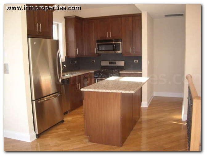 a kitchen with stainless steel appliances and wooden cabinets